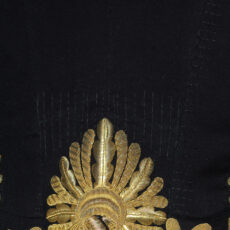 This is a close-up photograph showing detail on the Lieutenant-Governor uniform and the Conservator’s stitches.