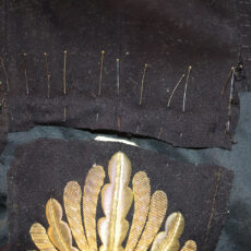 This is a photograph of pins holding pieces of the uniform together during the conservation process.