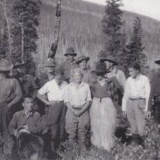 This is a black and white photograph, mountains in the background, showing Mary Gibson Henry, her husband, four children and some of the 1931 expedition crew.