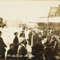 This is a black and white photograph of people at a train station in Ontario in 1915.