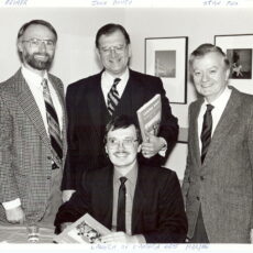 Four gentlemen in suits pose for a photo during National Film Week in Vancouver. From left to right: Archivist Derek Reimer, Provincial Archivist John Bovey, Archivist Dennis Duffy (below), Stanley Fox.