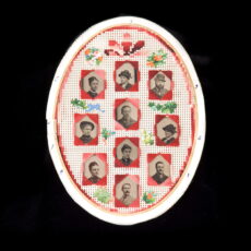 Ten black and white photographs of men and women are presented in an oval frame and decorated with needlepoint flowers.