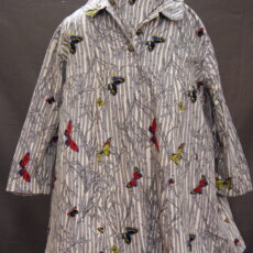 A maternity jacket with a pattern of colourful butterflies flying through grey-and-white bamboo.