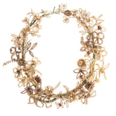 Garland made from woven human hair around wire, wrapped with green thread and decorated with faux pearls and metal beads.