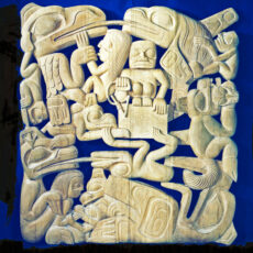 A pale cedar carving of intertwined Haida figures, including a fisherman and his wife who are surrounded by beings and creatures.